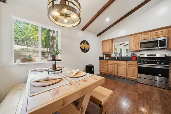 a kitchen with stainless steel appliances granite countertop a refrigerator a stove a sink and dishwasher