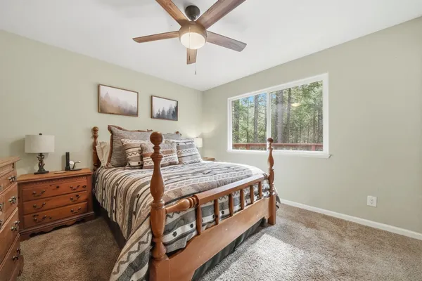 a bedroom with a bed and a chandelier