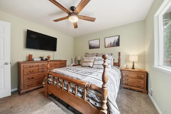 a bedroom with a bed and a mirror