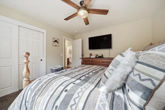 a bedroom with a bed and a television