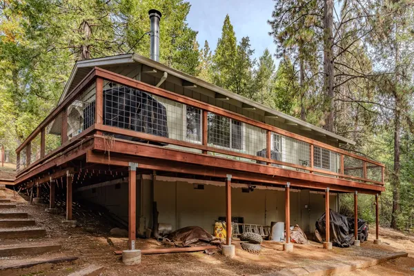 a view of balcony with wooden floor and fence