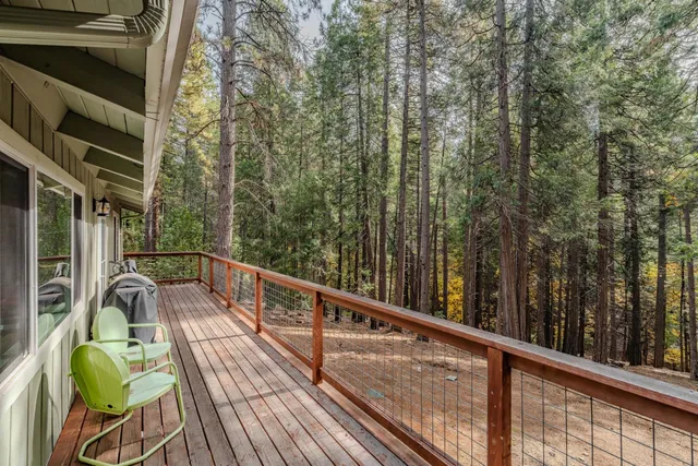 a view of balcony with chairs and wooden fence