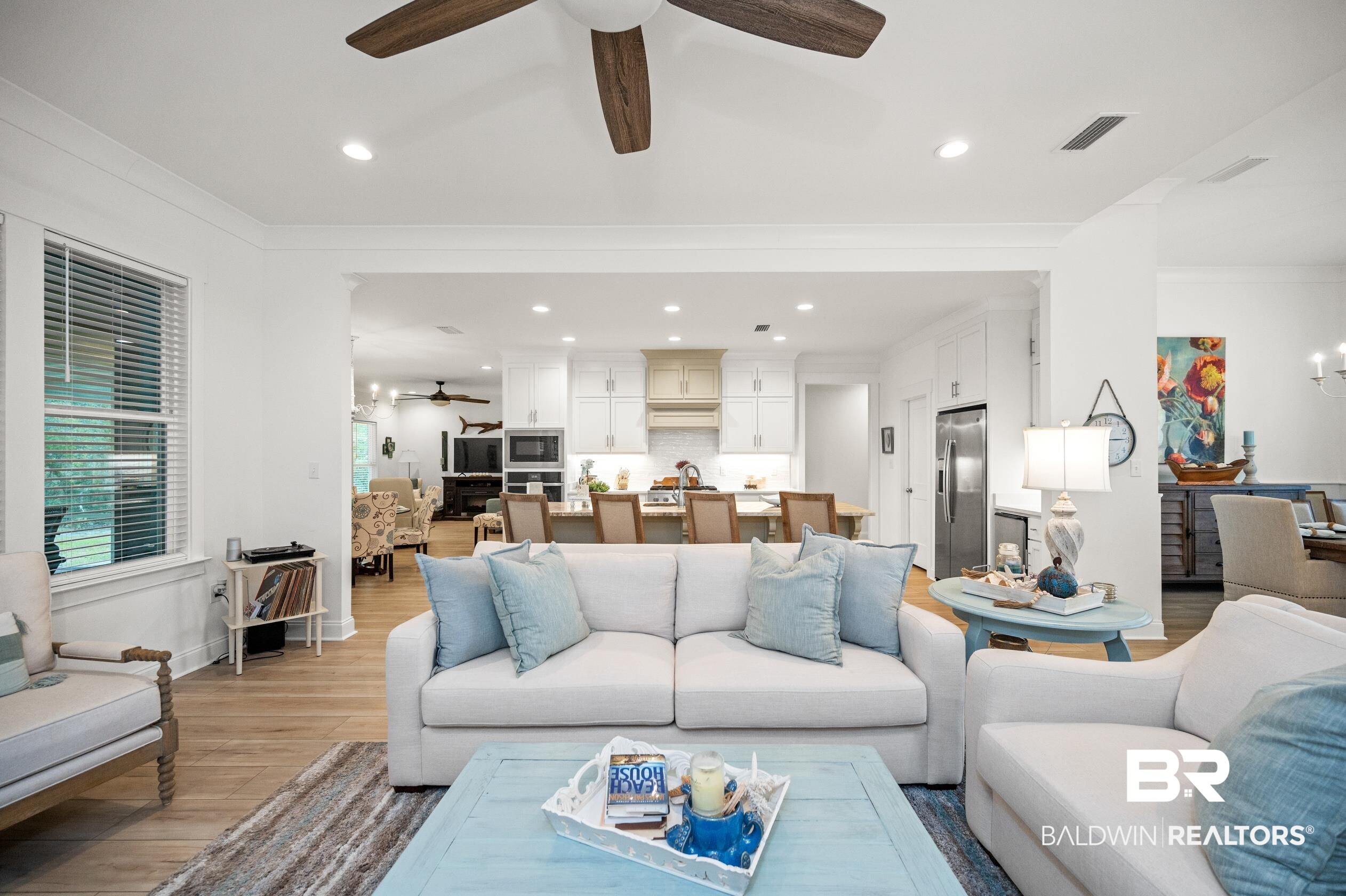 4601 Surrey Lane Orange Beach, AL 36561 - Photo 9 of 43 Living room featuring crown molding, ceiling fan, and light hardwood / wood-style floors