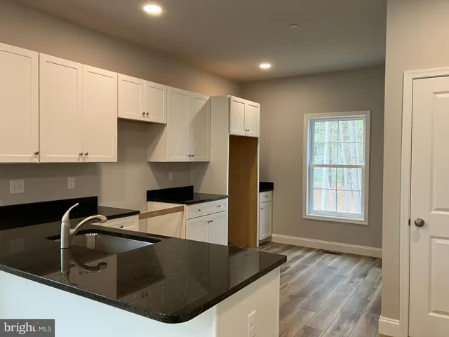 a kitchen with kitchen island a sink stove and refrigerator