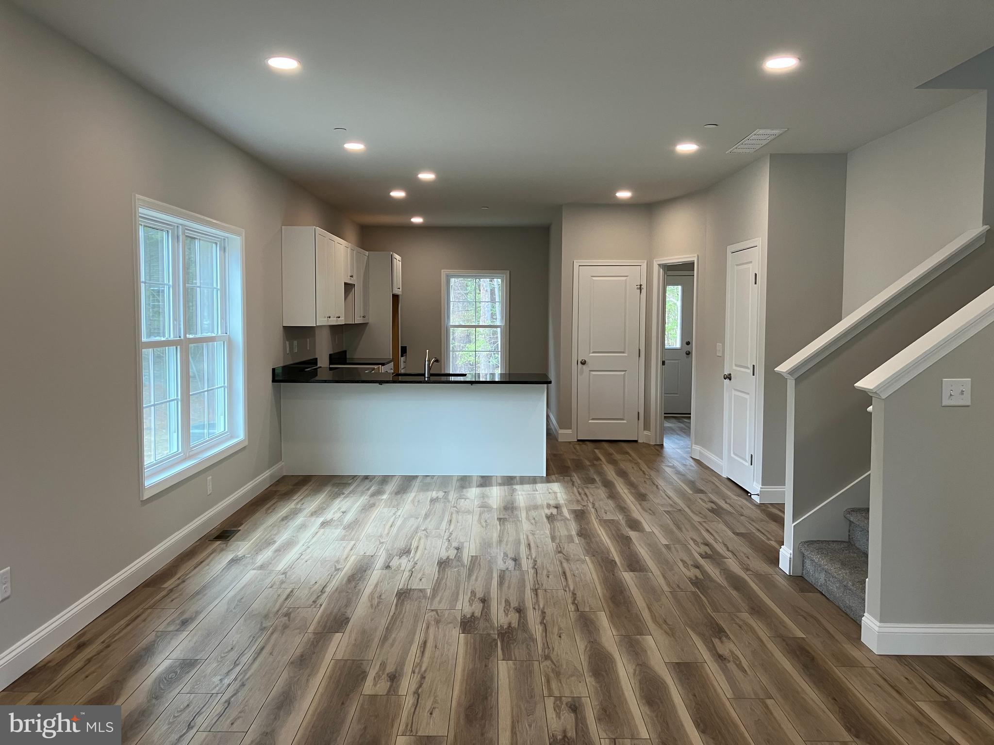 21133 Striper Run Rock Hall, MD 21661 - Photo 5 of 8 a view of a kitchen cabinets wooden floor and staircase