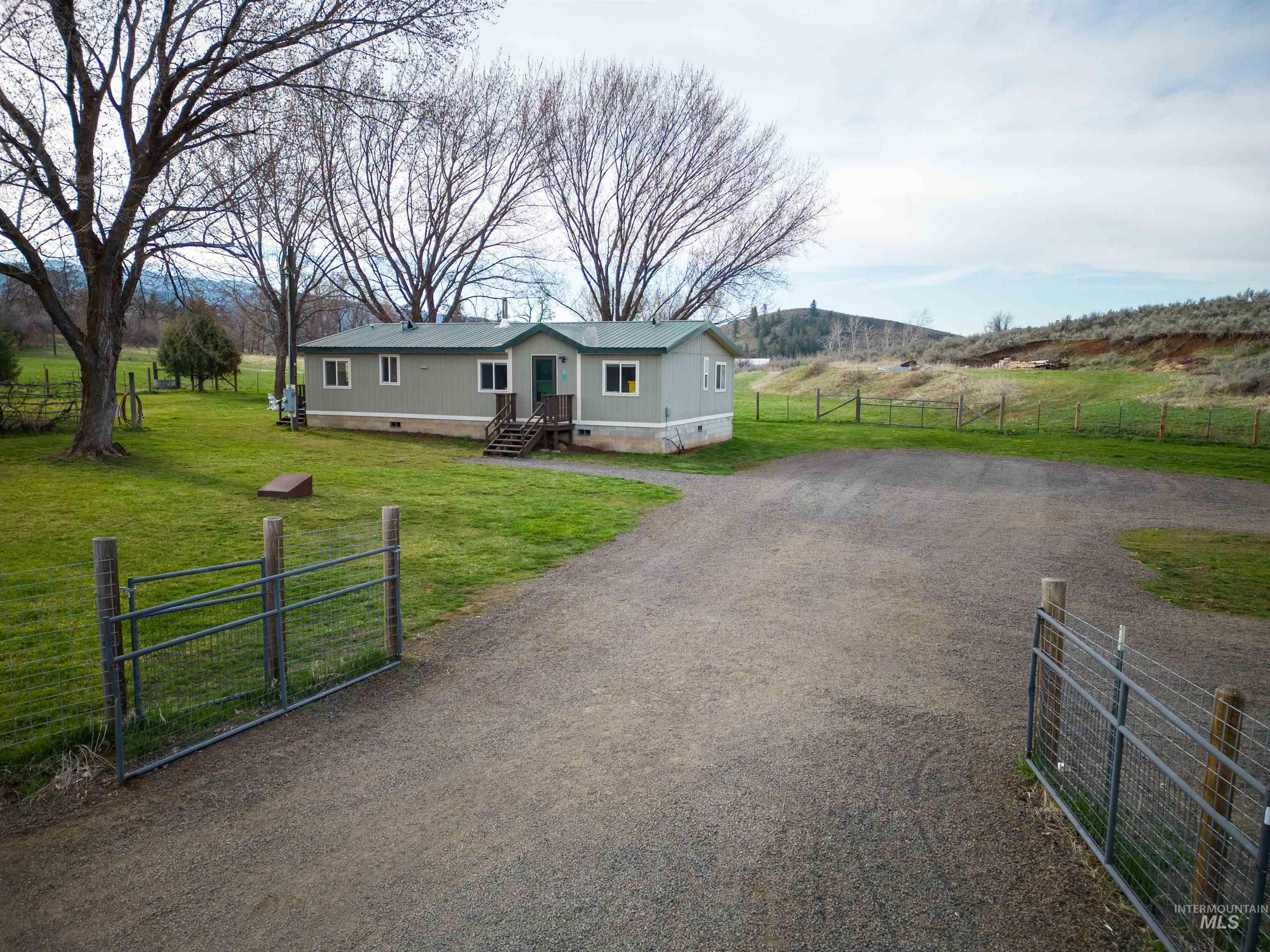 2605 West Frk Road Council, ID 83612 - Photo 1 of 34 Manufactured / mobile home featuring crawl space, a rural view, a metal roof, and a gate