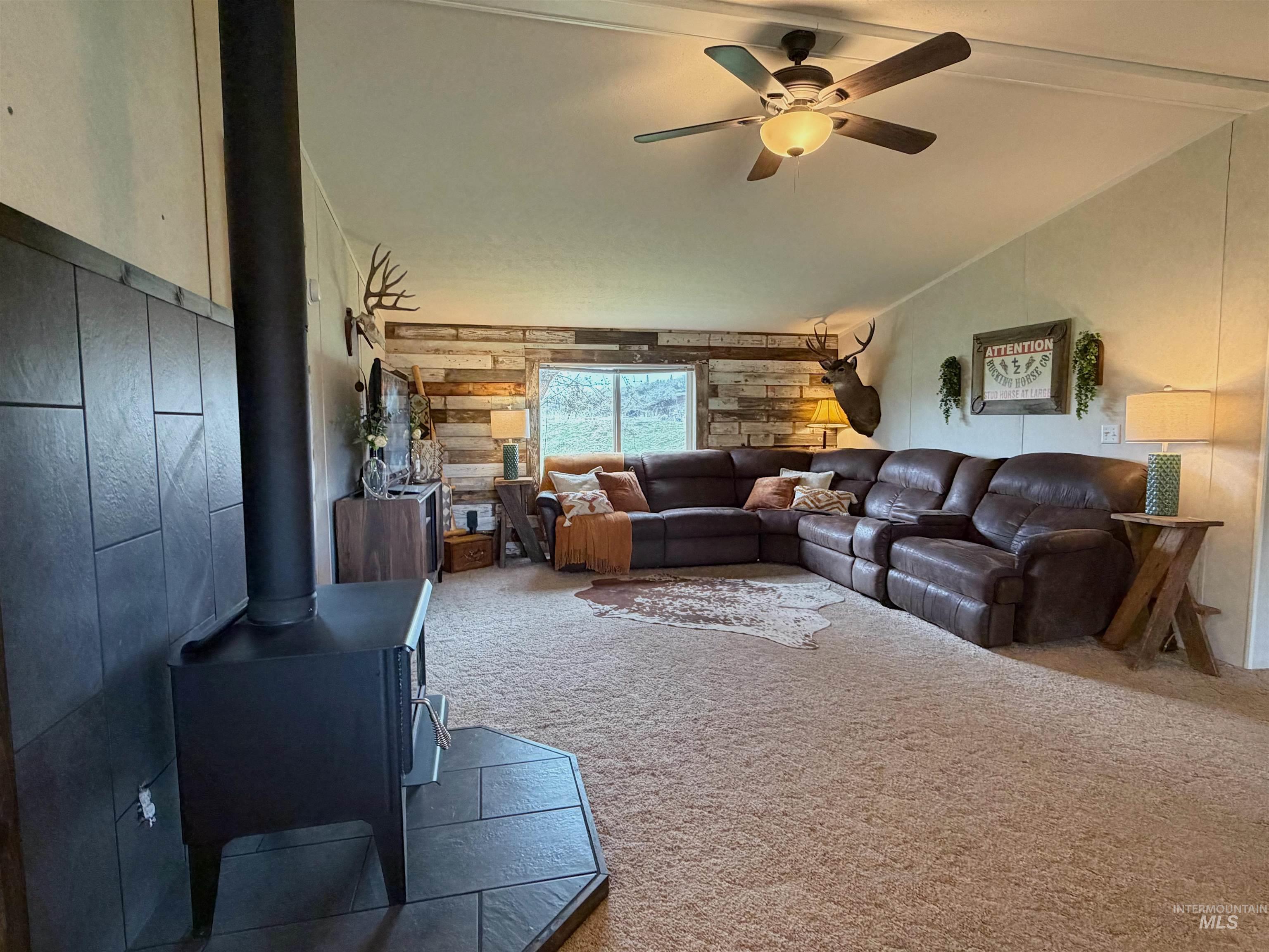 2605 West Frk Road Council, ID 83612 - Photo 15 of 34 Living room featuring carpet flooring, ceiling fan, and vaulted ceiling