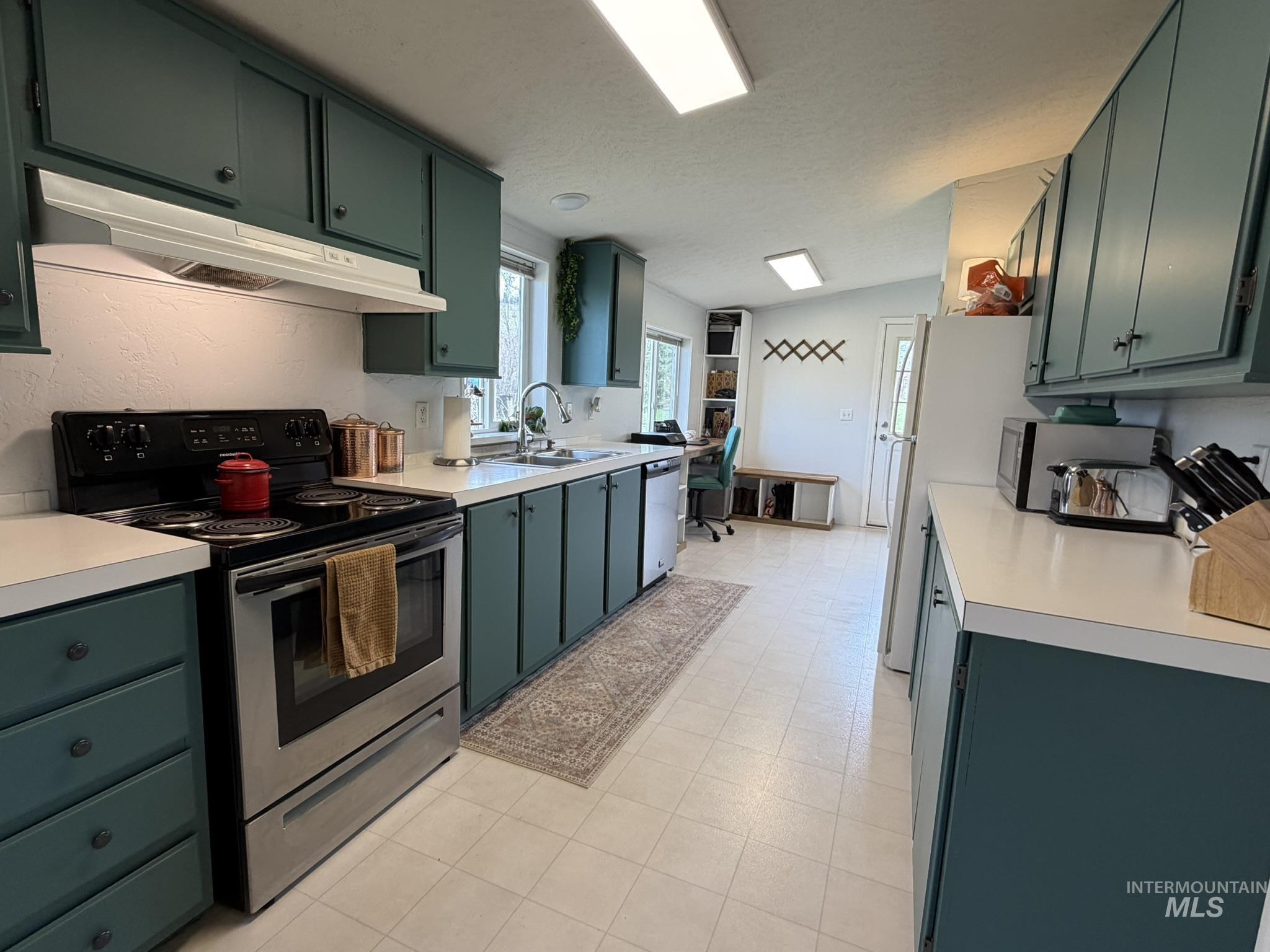 2605 West Frk Road Council, ID 83612 - Photo 18 of 34 Kitchen with green cabinets, stainless steel appliances, light countertops, and light flooring