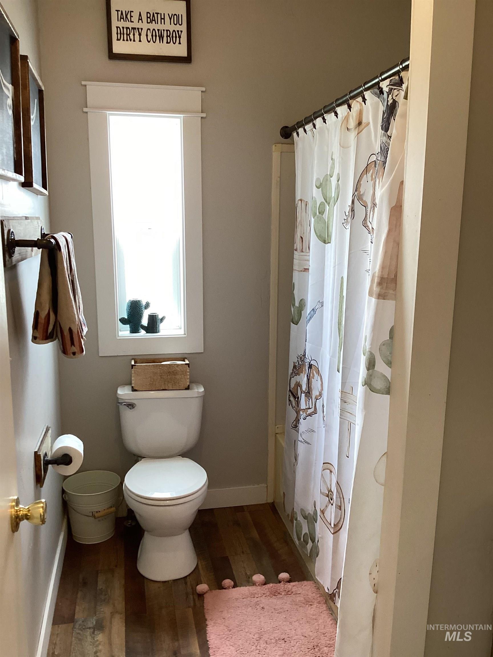2605 West Frk Road Council, ID 83612 - Photo 29 of 34 Full bathroom featuring dark wood finished floors and shower / tub combo with curtain