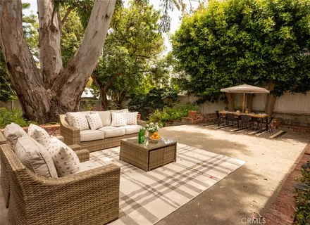 a view of the patio with couches and a fire pit
