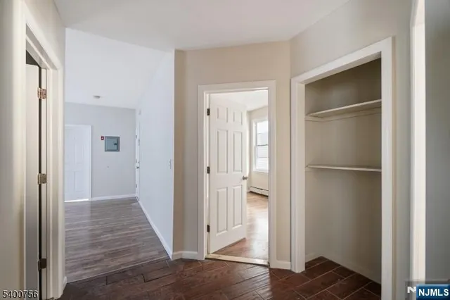a view of a hallway with wooden floor