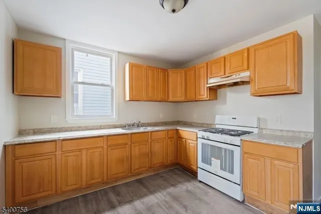 a kitchen with a sink stove and cabinets