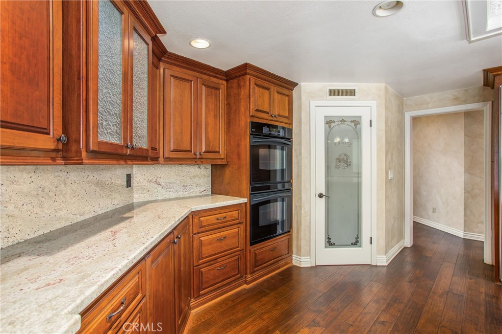6966 Ranch View Road Riverside, CA 92506 - Photo 12 of 73 wooden floor and cabinets in a kitchen