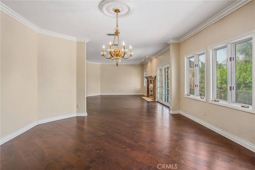 6966 Ranch View Road Riverside, CA 92506 - Photo 14 of 73 a view of a livingroom with wooden floor a chandelier and windows