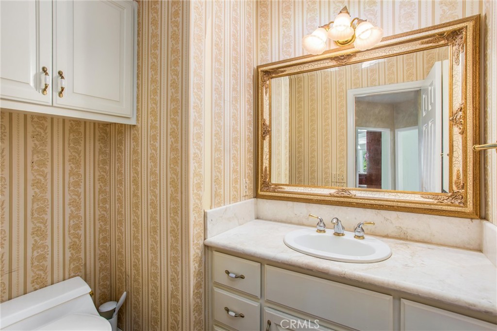 6966 Ranch View Road Riverside, CA 92506 - Photo 18 of 73 a bathroom with a sink and a mirror