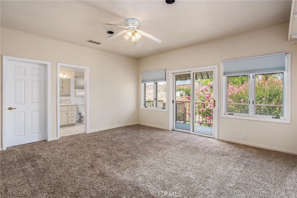 6966 Ranch View Road Riverside, CA 92506 - Photo 25 of 73 an empty room with windows and ceiling fan