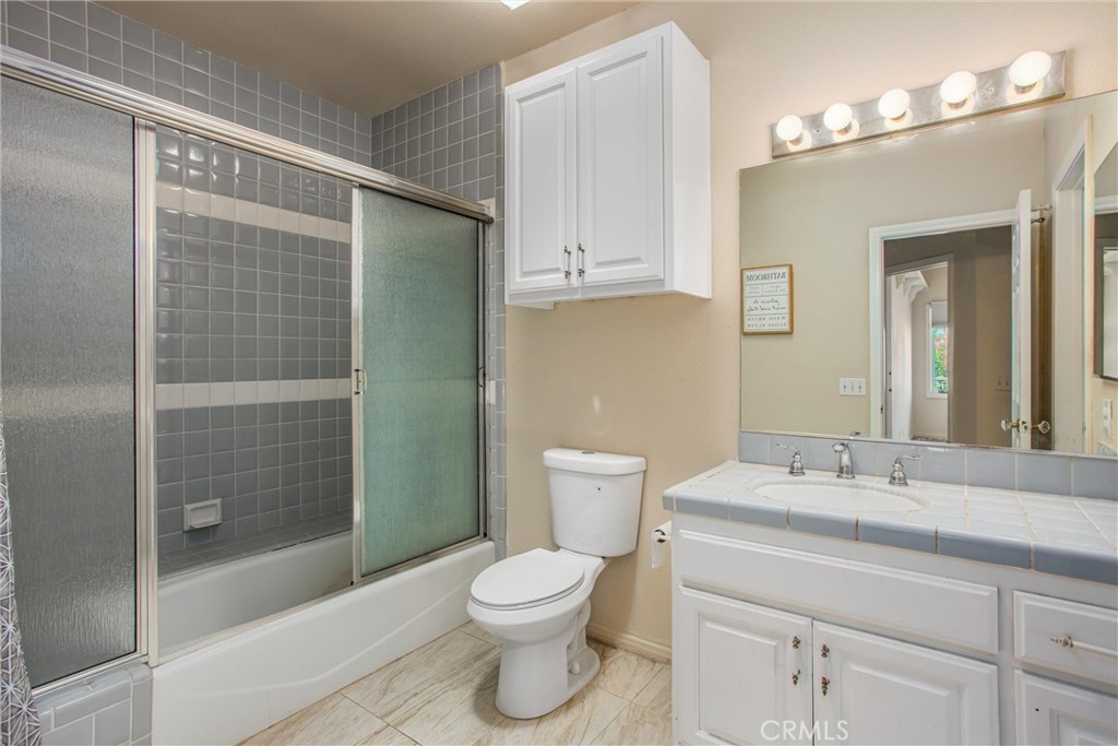 6966 Ranch View Road Riverside, CA 92506 - Photo 27 of 73 a bathroom with a toilet a sink and shower