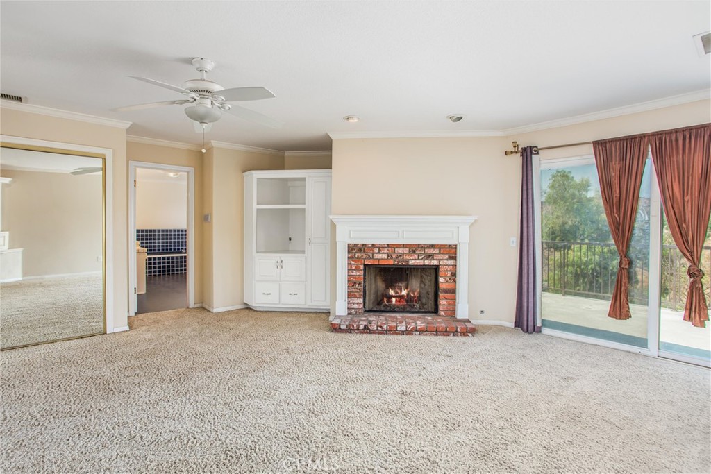 6966 Ranch View Road Riverside, CA 92506 - Photo 32 of 73 an empty room with windows and fireplace