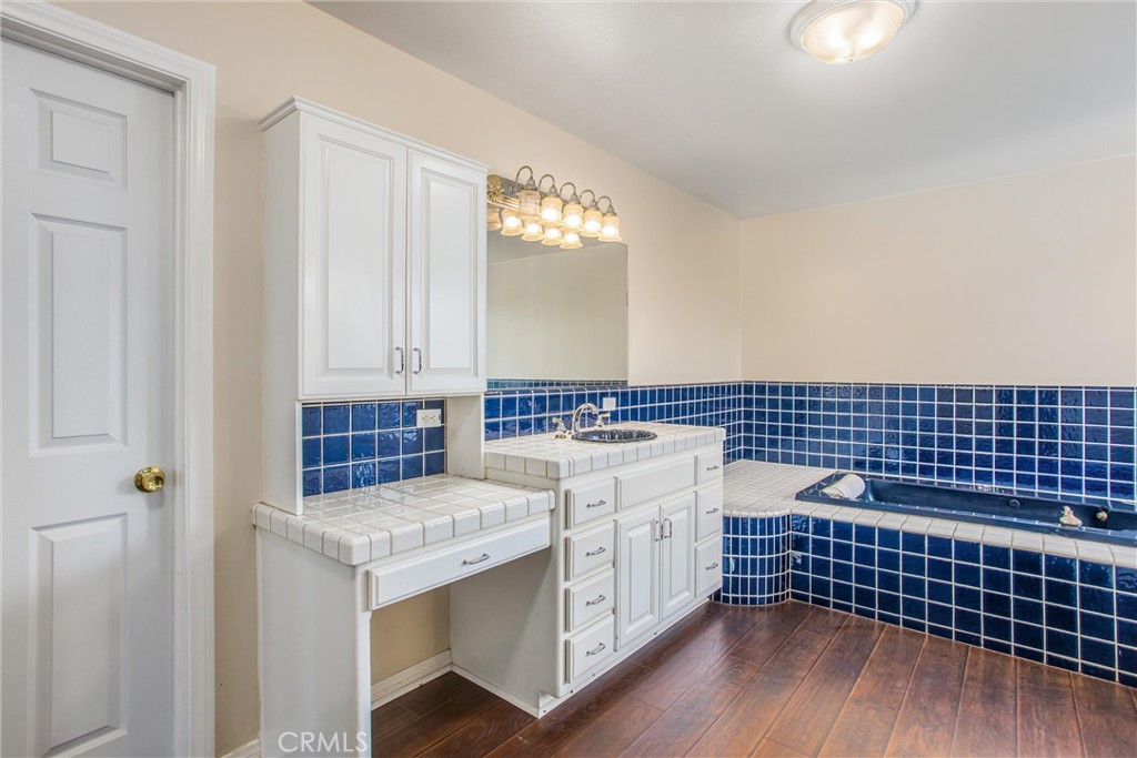 6966 Ranch View Road Riverside, CA 92506 - Photo 34 of 73 a kitchen with a sink and cabinets