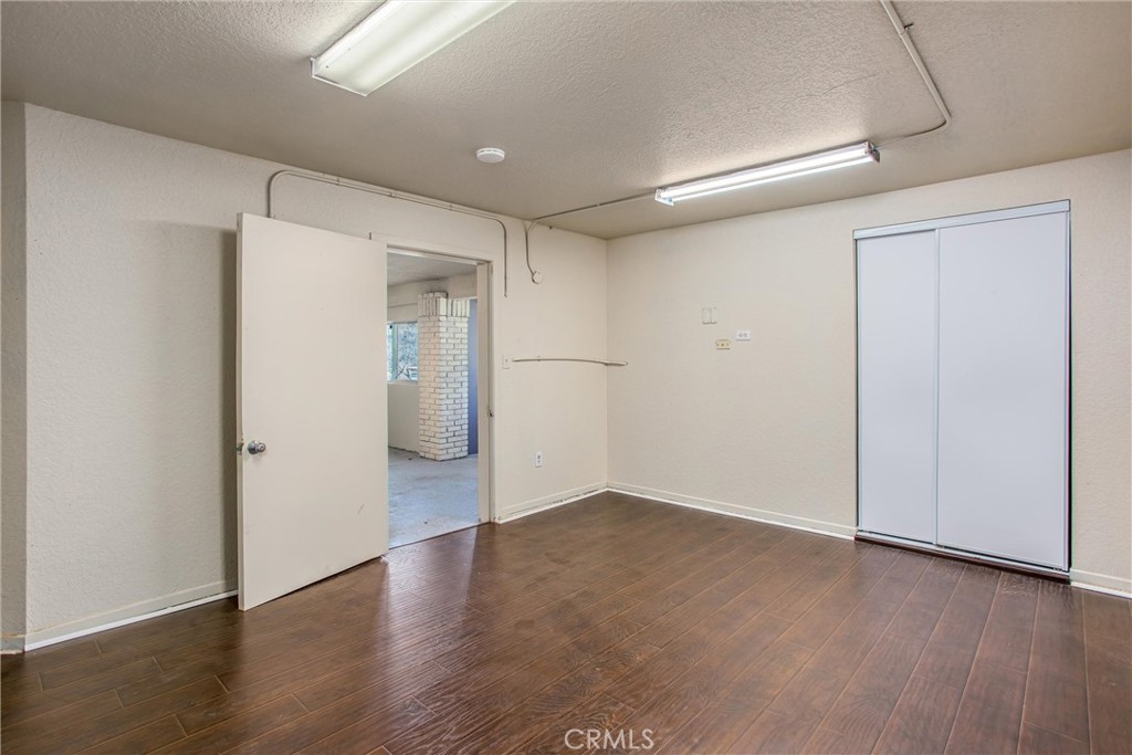 6966 Ranch View Road Riverside, CA 92506 - Photo 50 of 73 an empty room with wooden floor and windows