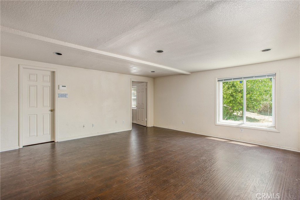 6966 Ranch View Road Riverside, CA 92506 - Photo 52 of 73 an empty room with wooden floor and windows