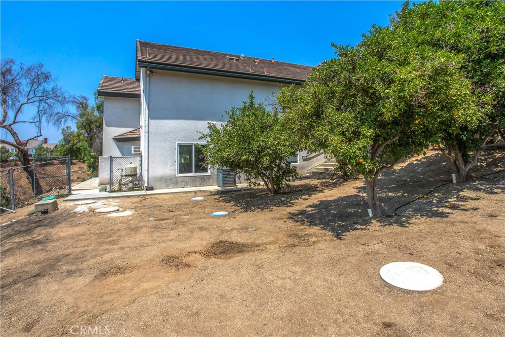 6966 Ranch View Road Riverside, CA 92506 - Photo 61 of 73 a view of a house with backyard space and a tree