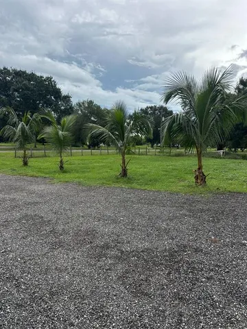 a view of outdoor space with playground and green space