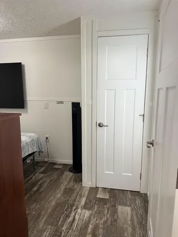 a view of a room with wooden floor and wardrobe