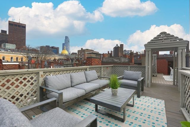 a view of roof deck with seating space and barbeque oven
