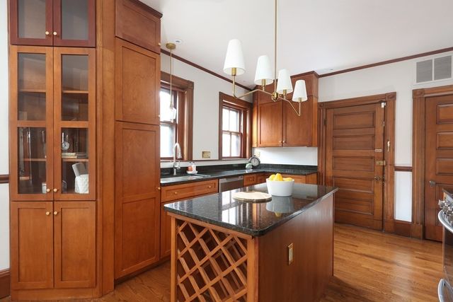 a kitchen that has a sink and a wooden floor