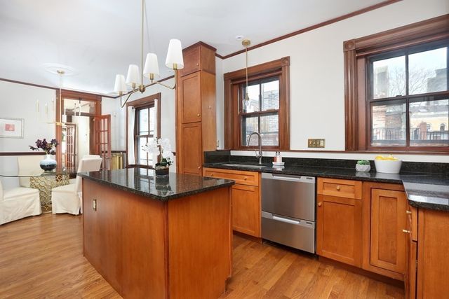 a view of a kitchen with granite countertop a large window and counter space