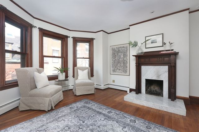a living room with furniture and a fireplace
