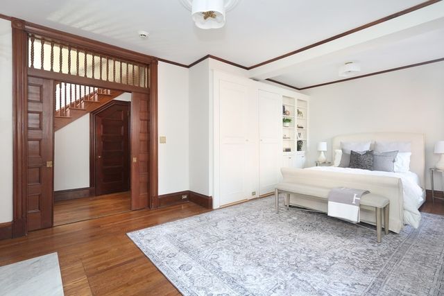 a spacious bedroom with a bed and a table