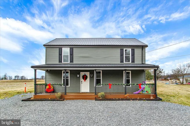 a front view of a house with an outdoor seating