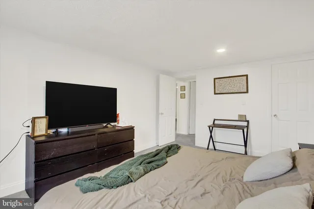 a bedroom with a bed and a flat screen tv