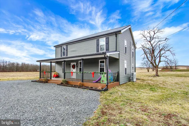a view of a house with pool and a yard