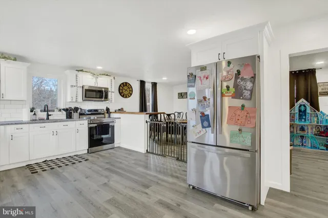 a kitchen with granite countertop stainless steel appliances and wooden cabinets