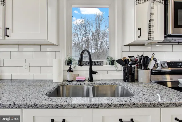 a kitchen with granite countertop a sink and a counter top space