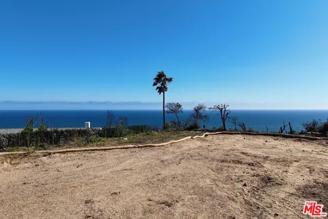 a view of a dirt road with mountain view
