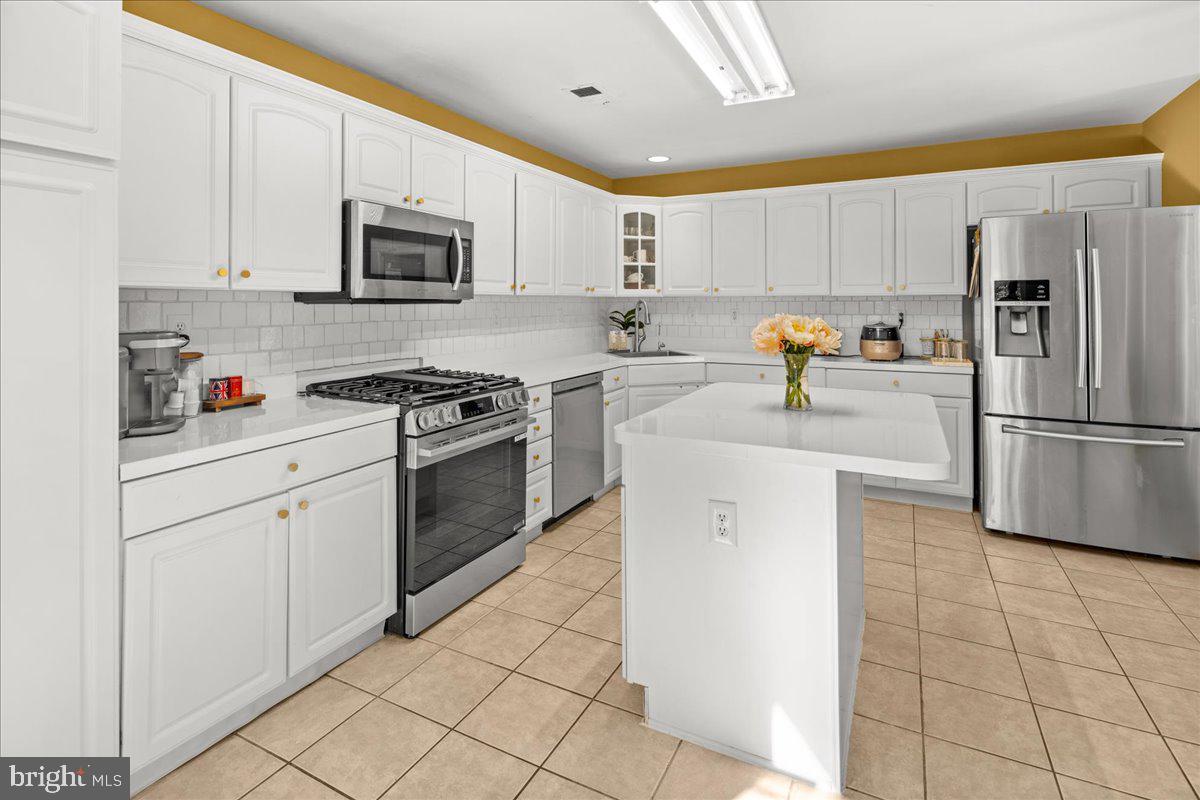 316 Watkins Road Pennington, NJ 08534 - Photo 13 of 37 a kitchen with white cabinets and stainless steel appliances