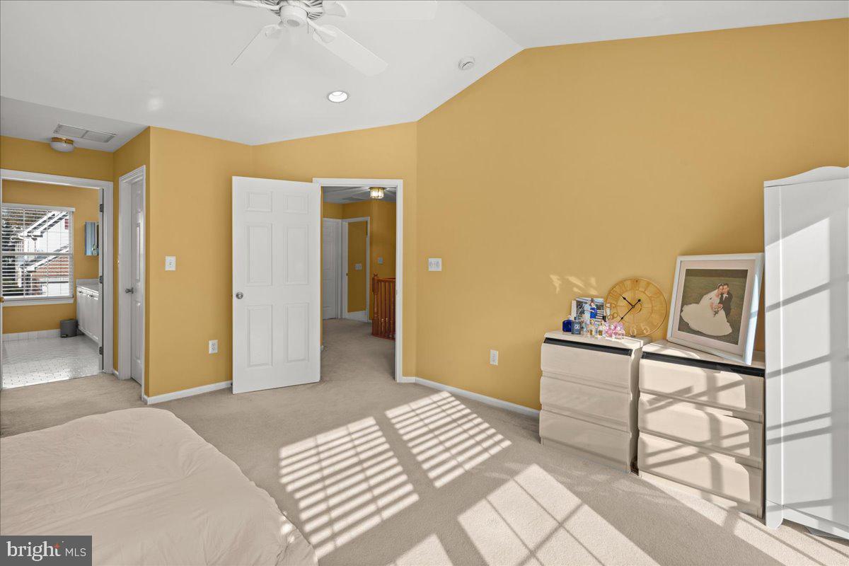 316 Watkins Road Pennington, NJ 08534 - Photo 20 of 37 a bedroom with a bed and a chandelier