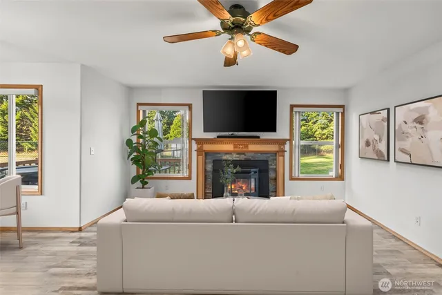 a living room with furniture a fireplace and a flat screen tv