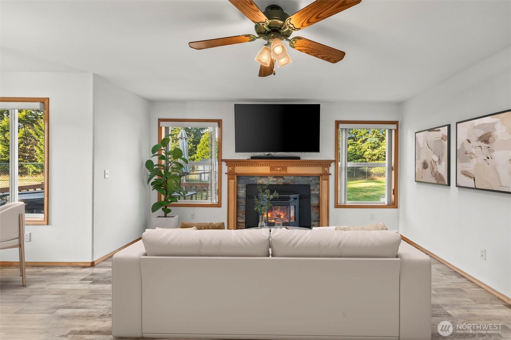 9117 336th Street South Roy, WA 98580 - Photo 11 of 38 a living room with furniture a fireplace and a flat screen tv