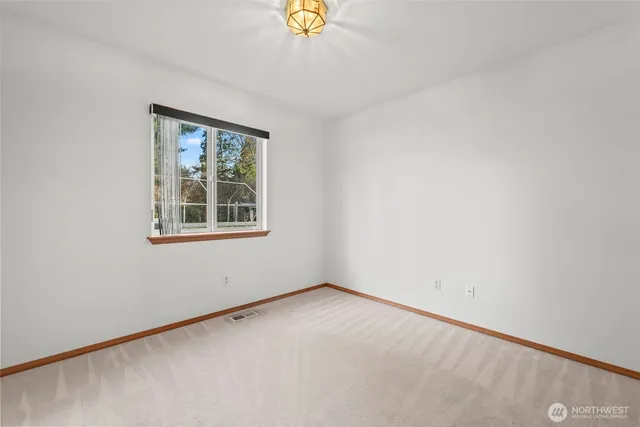 an empty room with windows and closet