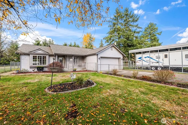 an aerial view of a house with a garden and lake view