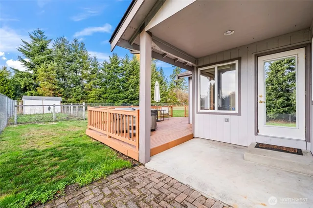 a view of a chairs and table on the wooden deck