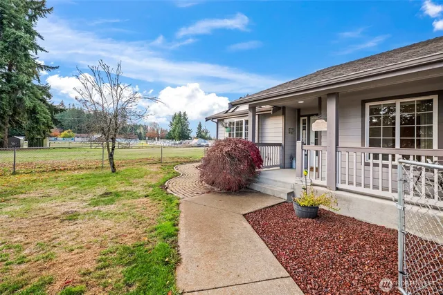 a view of a house with backyard and sitting area