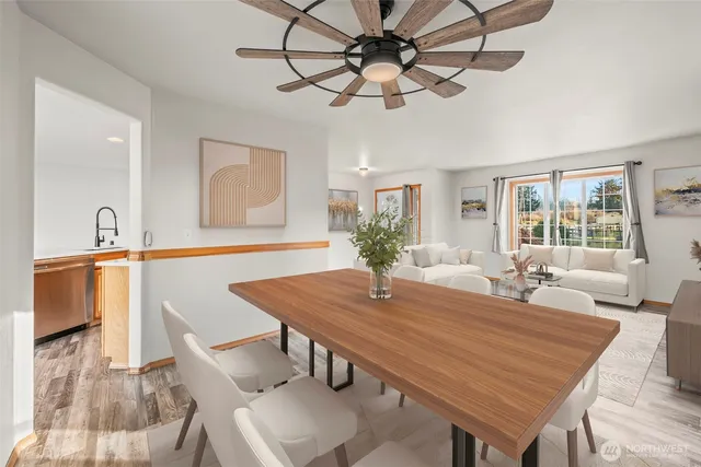 a dining room with wooden floor a chandelier a wooden table and chairs