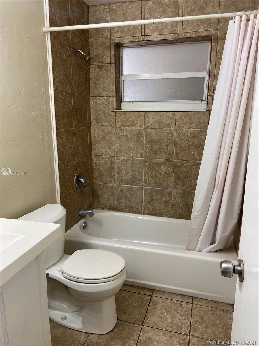 1509 Pine Tree Court Riviera Beach, FL 33404 - Photo 14 of 19 a bathroom with a toilet and a shower