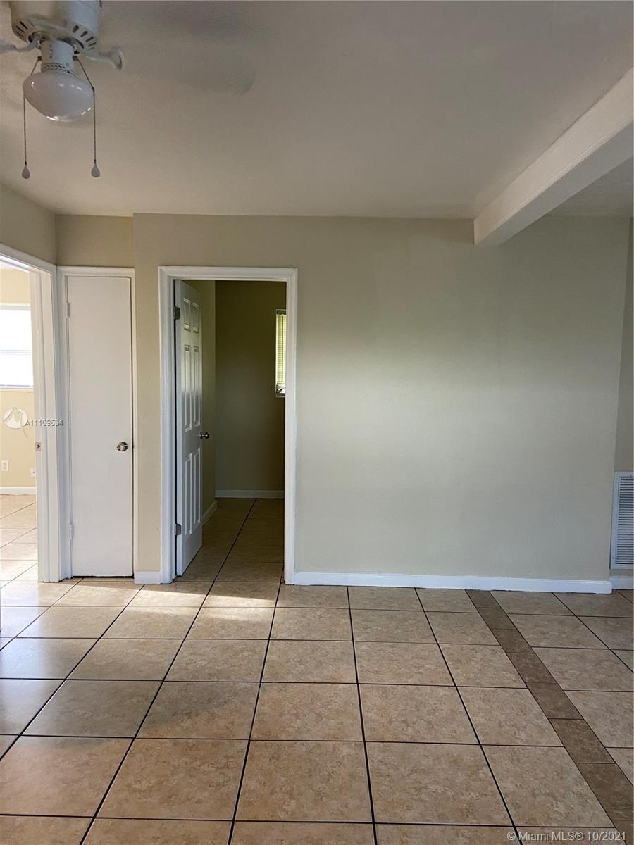 1509 Pine Tree Court Riviera Beach, FL 33404 - Photo 16 of 19 a view of a livingroom with an empty space and a kitchen